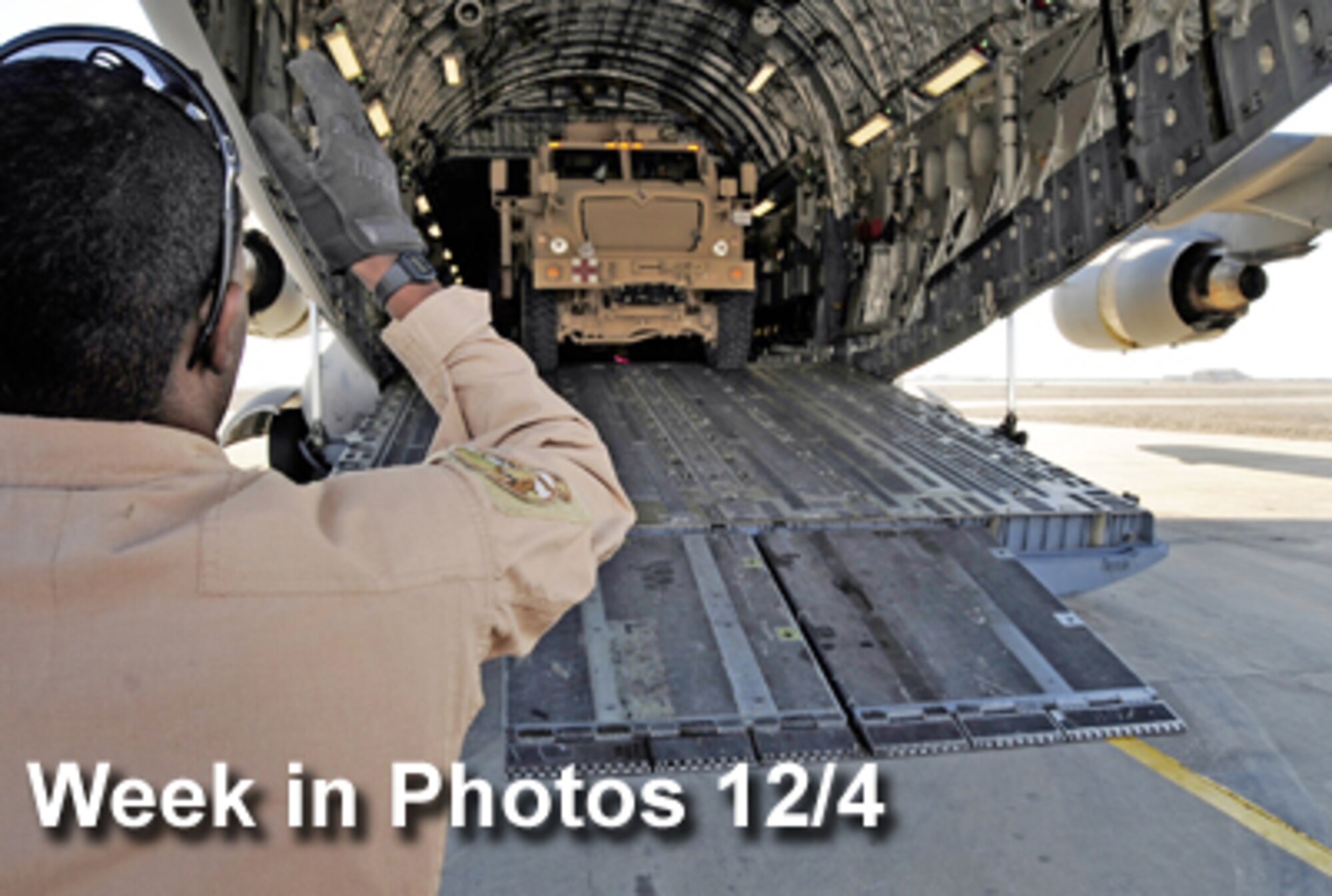 Air Force Week in Photos for Dec. 4 highlights photos from around the Air Force. In this photo by Senior Airman Tony R. Ritter, Airman 1st Class Raheem Crockett guides a mine-resistant ambush protected vehicle as it is loaded on a C-17 Globemaster III Dec. 1, 2009, on the Ali Base, Iraq, airfield. (U.S. Air Force photo illustration) 
