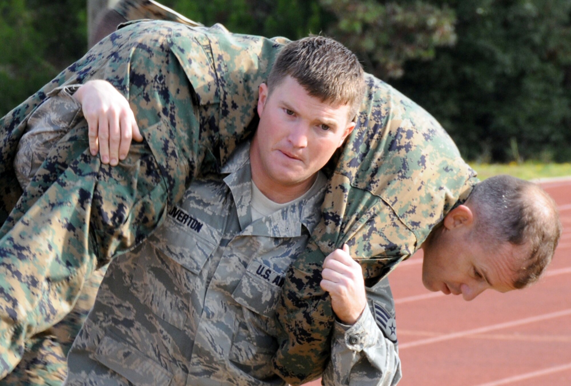 Staff Sgt. William Overton carries Marine Lt. Col. James Wellons during the under fire maneuver portion of the Marine combat fitness test Nov. 25, 2009, at Eglin Air Force Base, Fla. Sergeant Overton is assigned to the 96th Logistics Readiness Squadron, and Colonel Wellons is the 501st Marine Fighter Attack Training Squadron commander. (U.S. Air Force photo/Staff Sgt. Bryan Franks)