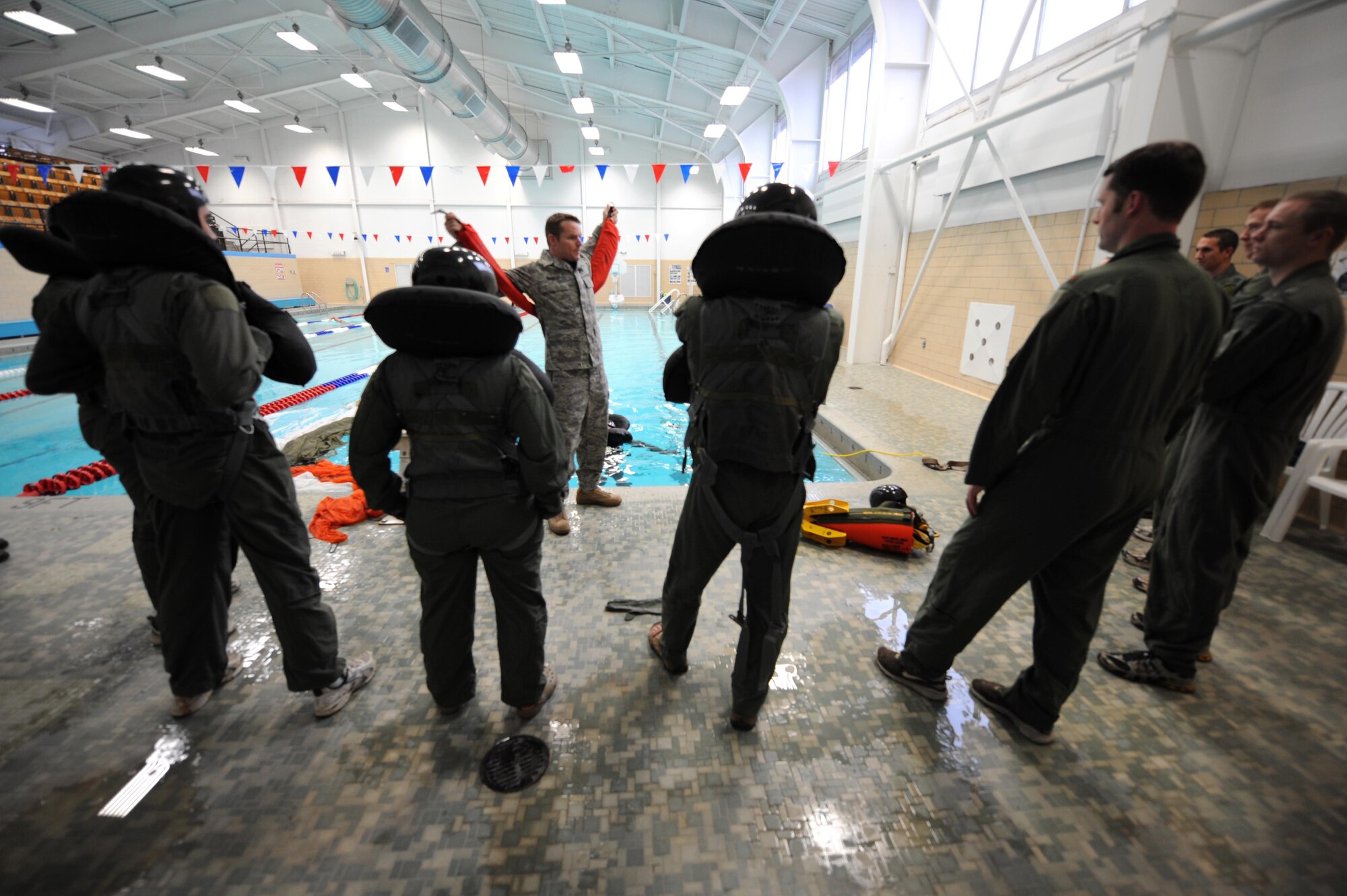 ELLSWORTH AIR FORCE BASE, S.D.-- Senior Airman Brandon Dunphy, 28th Operations Support Squadron Survival, Evasion, Resistance and Escape (SERE) NCO in charge, trains 34th Bomb Squadron aircrew on water survival procedures, Dec. 1. The purpose of water survival training is to familiarize aircrew with some of the scenarios they may encounter should their plane go down over water. (U.S. Air Force photo/Airman 1st Class Corey Hook)
