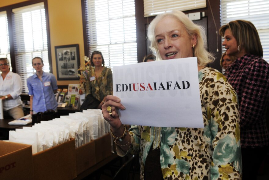 Marsha Buzzell holds up the new EDIUSAIAFAD logo during a Heart Link tour for military spouses Nov.13. U. S. Air Force photo by Sue Sapp