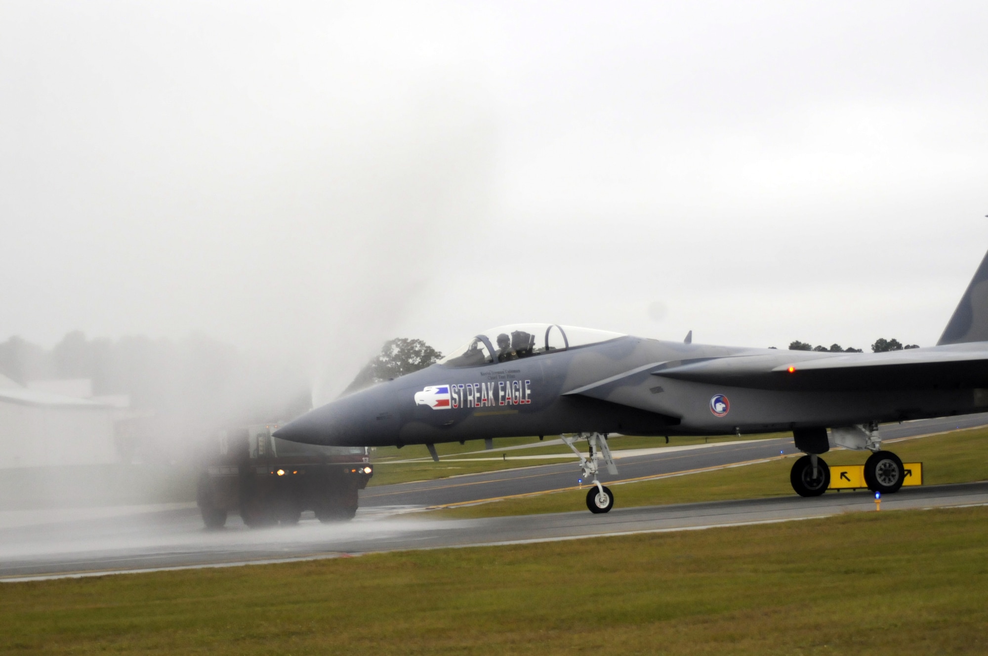 A Robins firetruck shoots a stream of water over the F-15 after Lt. Col. Coleman's final flight. U. S. Air Force photo by Sue Sapp