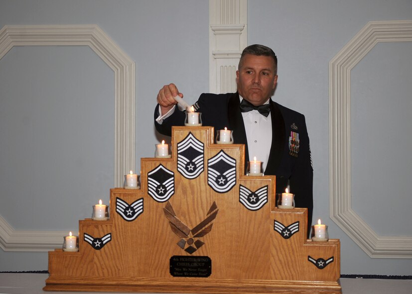Chief Master Sgt. David Seia, 4th Aircraft Maintenance Squadron superintendent, lights the top enlisted Airman candle at the Enlisted Heritage Banquet on Seymour Johnson Air Force Base, N.C., Dec. 1, 2009. Chief Seia sewed on his new rank Dec. 1 and is Seymour Johnson's newest chief. (U.S. Air Force photo/Senior Airman Ciara Wymbs) 