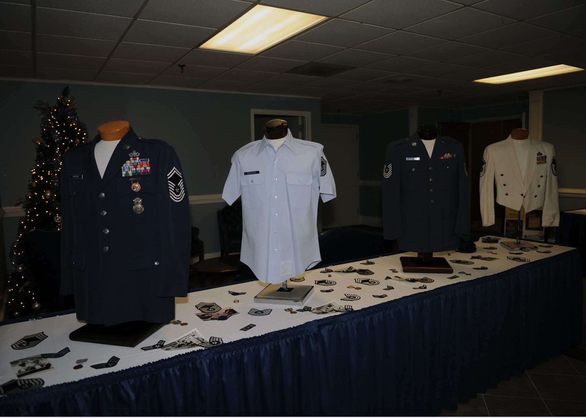 Air Force uniforms provided by retired Chief Master Sgt. Bob Forsythe sit on display during the Enlisted Heritage Banquet on Seymour Johnson Air Force Base, N.C., Dec. 1, 2009. The Enlisted Heritage Banquet celebrated the enlisted corps' history, while honoring the 50th anniversary of the rank of chief master sergeant. (U.S. Air Force photo/Senior Airman Ciara Wymbs)  