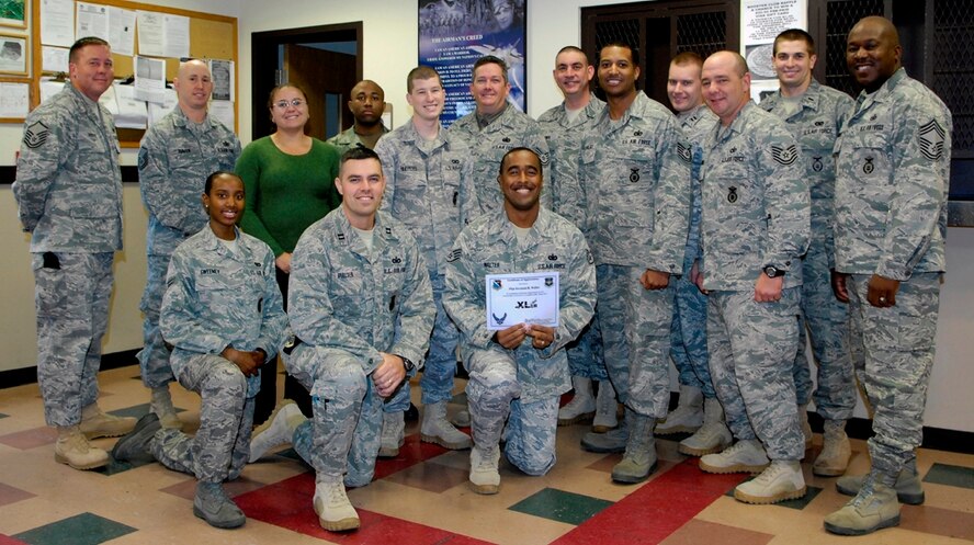LAUGHLIN AIR FORCE BASE, Texas – Staff Sgt. Jovonnie Walter, 47th Security Forces Squadron, poses with fellow members of his squadron after being presented the XLer of the week award by Col. Jeffrey McDaniels, 47th Flying Training Wing commander, here Dec. 1. (U.S. Air Force photo by Jose Mendoza)