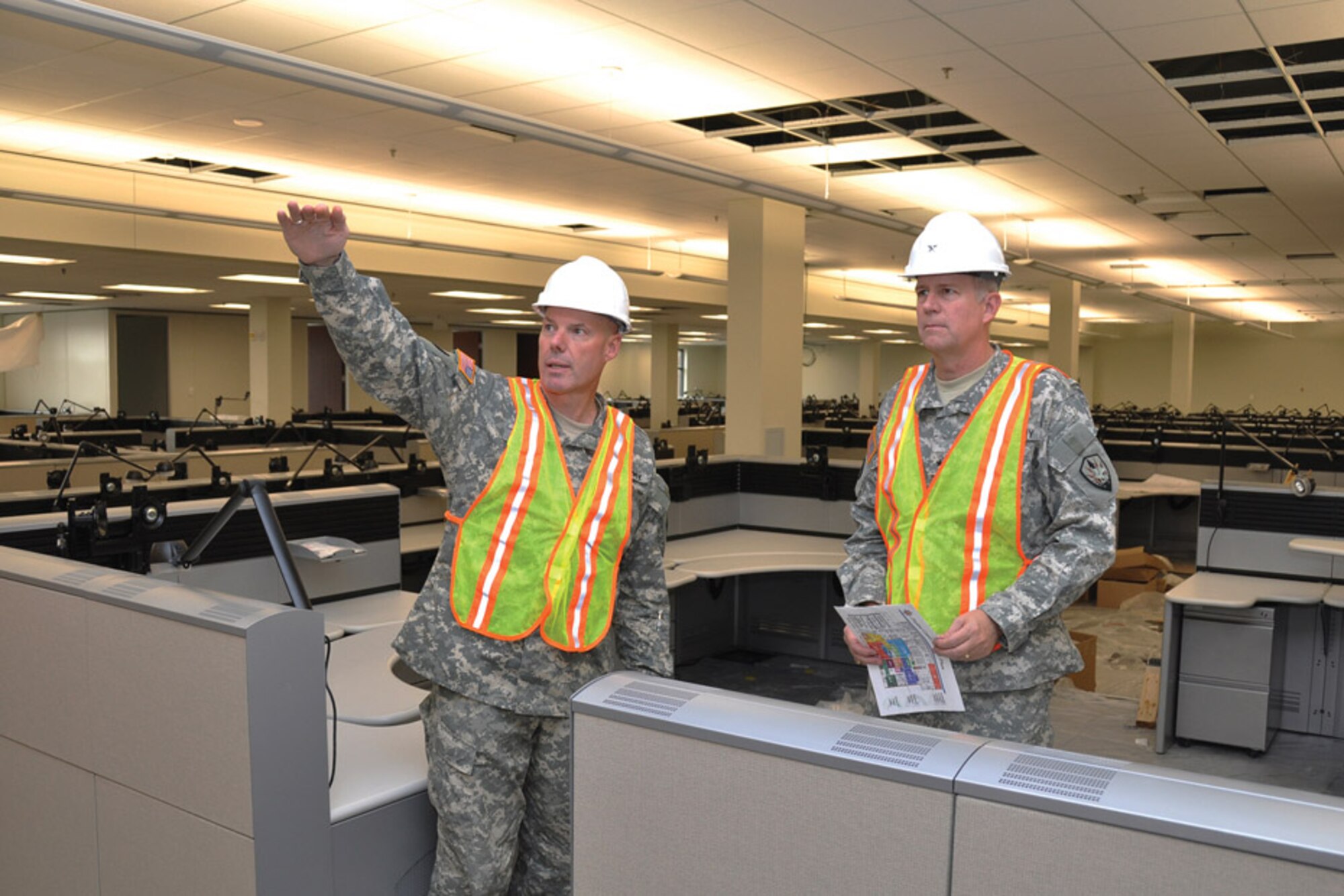 SCOTT AIR FORCE BASE, Ill. -- Brig. Gen. Gregory Couch, left, U.S. Transportation Command assistant director of Operations for Mobilization, talks with Brig. Gen. Michael J. Lally, USTRANSCOM director of Operations and Plans, Nov. 13, during a tour of the command's new Bldg. 1900 West Fusion Center. (Photo courtesy/ Bob Fehringer)