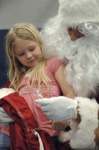 Taylor Lippy sits on Santa's lap at the annual base Holiday Tree Lighting ceremony at the Youth Programs Center here Dec. 2. Charleston AFB hosted the annual event which included caroling, crafts, awards and a special appearance by Santa Claus. Taylor is the daughter of Tech. Sgt. Keith Lippy who is with the 437th Security Forces Squadron.  (U.S. Air Force photo/ Airman 1st Class Lauren Laidlaw)