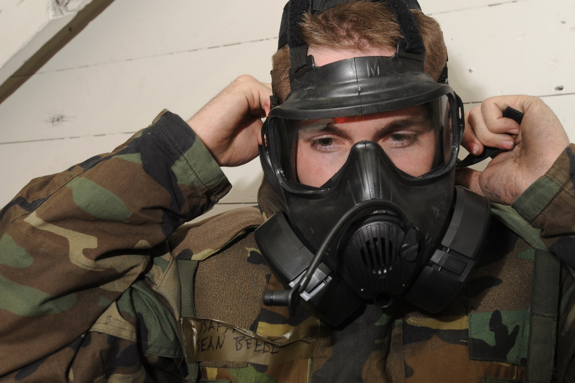 ELMENDORF AIR FORCE BASE, Alaska -- Airman 1st Class Sean Beebe, 3rd Medical Support Squadron, dons his gas mask during chemical attack for the base wide exercise, Polar Force 10-1 Dec. 3. The exercise uses a variety of scenarios that test the Arctic Warriors ability to handle real world situations. (U.S. Air Force photo/ Staff Sgt. Joshua Garcia)