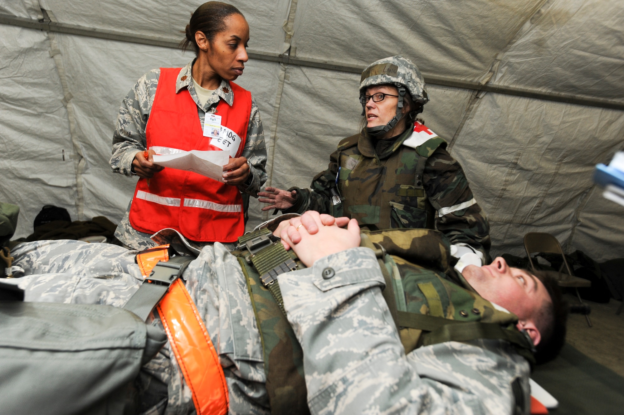 ELMENDORF AIR FORCE BASE, Alaska -- Captain Cynthia Lang, 3rd Inpatient Squadron, tells Major, LaRhonda Gray, a member of the base Exercise Evaluation Team, how she would treat Staff Sgt. Chris Ellis, 3rd Equipment Maintenance Squadron, for his conditions during an inject for the base wide exercise, Polar Force 10-1 Dec. 3. The exercise is made up of a variety of scenarios that test the Arctic Warriors ability to handle real world situations. (U.S. Air Force photo/ Staff Sgt. Joshua Garcia