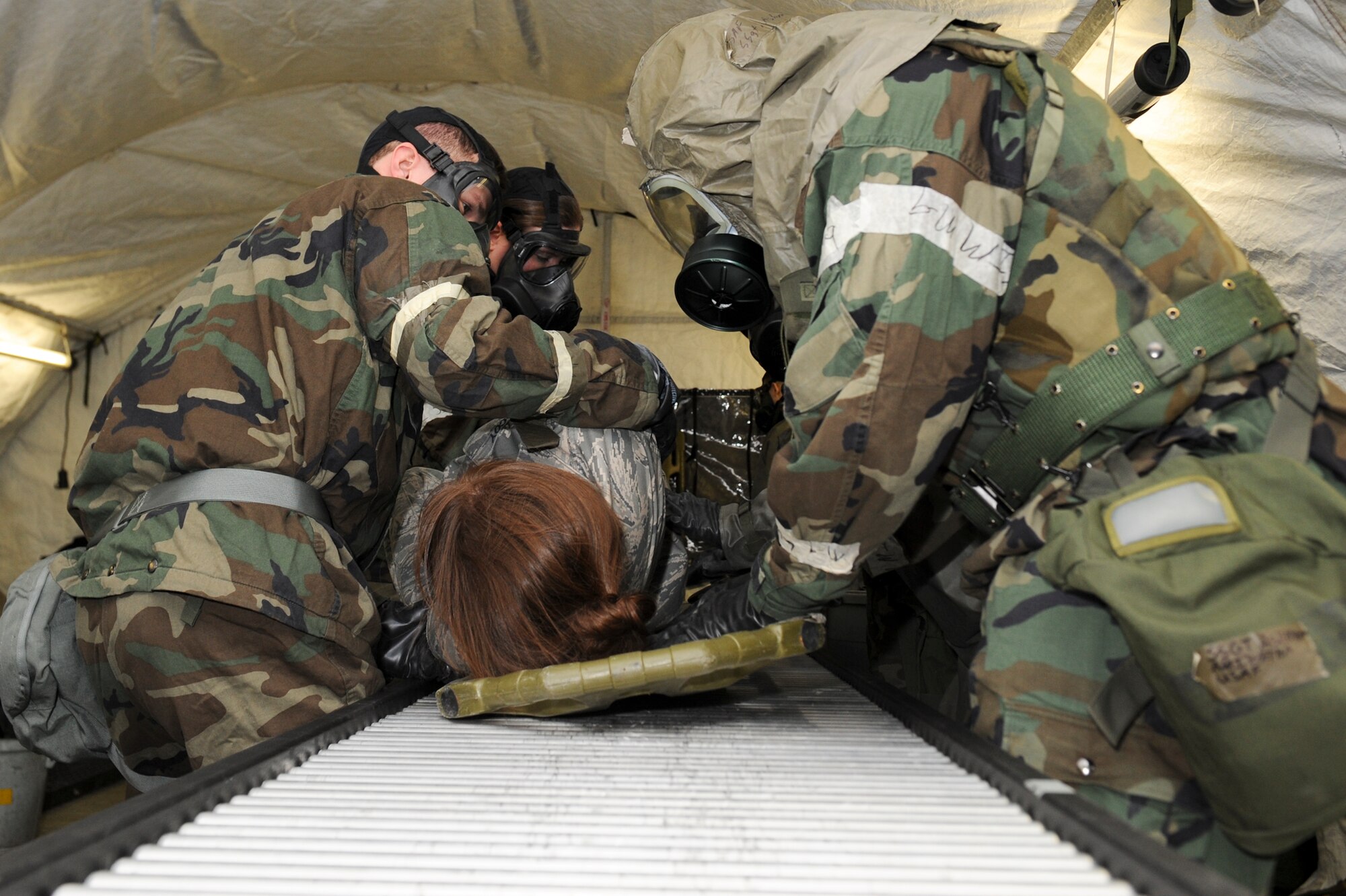 ELMENDORF AIR FORCE BASE, Alaska -- Members from the 3rd Medical Group decontaminate a victim during a medical inject for the base wide exercise, Polar Force 10-1 Dec. 3. Victims that show symptoms of being in a chemical attack are decontaminated prior to receiving further medical attention. The exercise contains a variety of scenarios that test the Arctic Warriors ability to handle real world situations. (U.S. Air Force photo/ Staff Sgt. Joshua Garcia)
