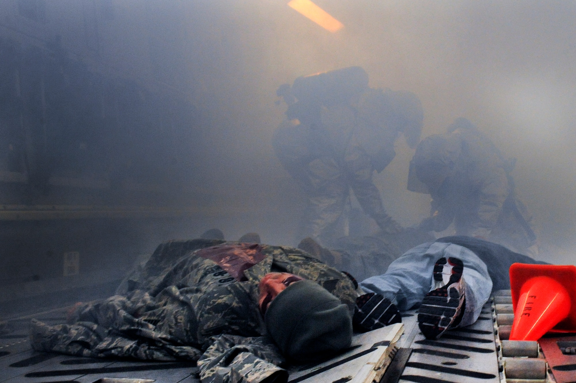 ELMENDORF AIR FORCE BASE, Alaska -- Firefighters assigned with the 3rd Civil Engineer Squadron, search for victims on a C-17 Globamaster during a mass casualty inject, for the base wide exercise, Polar Force 10-1 Dec. 3. The exercise is made up of a variety of scenarios that test the arctic warriors ability to handle real world situations. (U.S. Air Force photo/ Staff Sgt. Joshua Garcia)