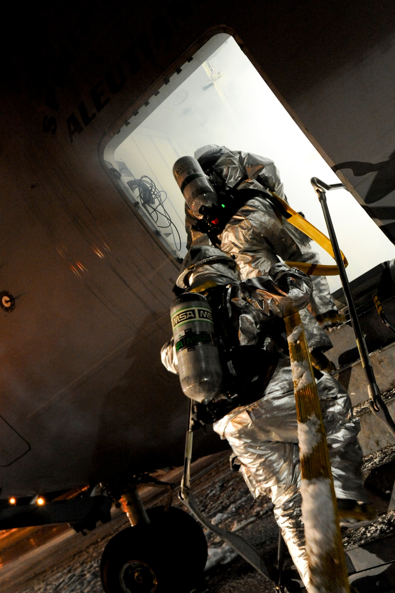 ELMENDORF AIR FORCE BASE, Alaska -- Firefighters assigned to the 3rd Civil Engineer Squadron, enter a C-17 Globemaster III during a mass casualty inject for the base wide exercise, Polar Force 10-1 Dec. 3. The exercise is made up of a variety of scenarios that test the arctic warriors ability to handle real world situations. (U.S. Air Force photo/ Staff Sgt. Joshua Garcia)