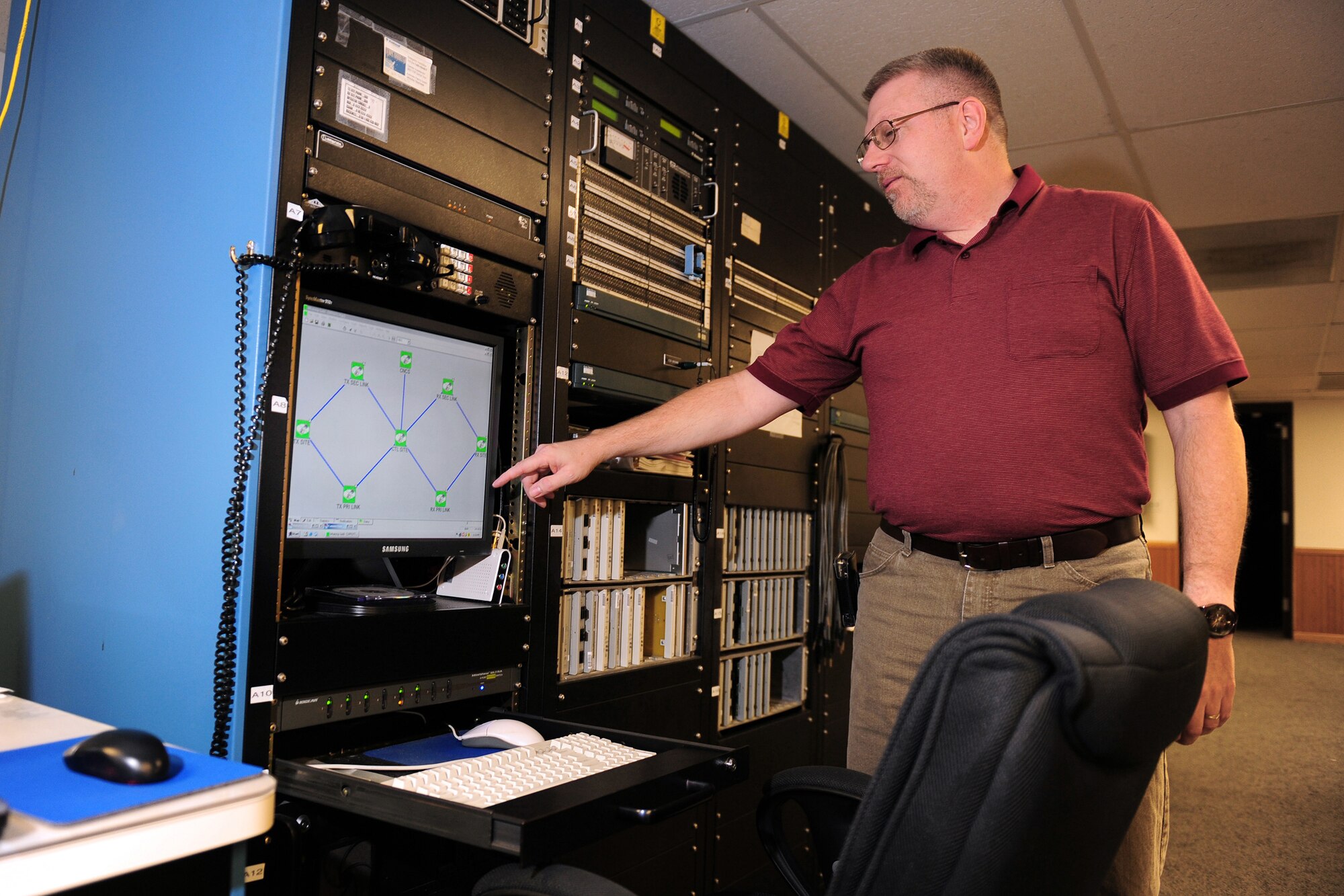 Dave Clingerman explains how he monitors antennas for the Elkhorn and Scribner Communication Sites Nov. 5, 2009, from a detached facility located near Elkhorn, Neb. Mr. Clingerman is a telecommunications specialist with the 55th Strategic Communications Squadron from Offutt Air Force Base, Neb. (U.S. Air Force photo/Josh Plueger)