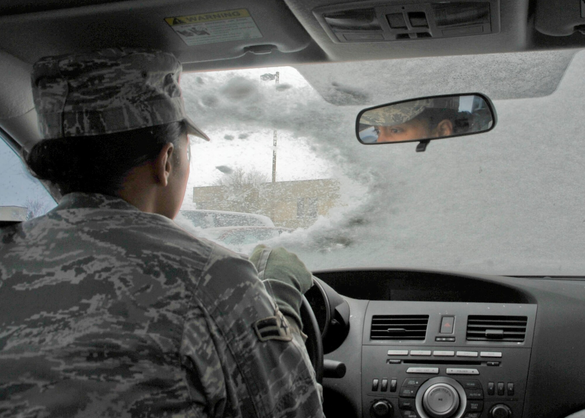 CANNON AIR FORCE BASE, N.M. -- Using the peephole method of clearing your windshield during a snowy day is one way not to guarantee a safe holiday season.  Drivers should clear their entire windshield as well as the back and side windows before heading to grandma's house. (U.S. Air Force photo illustration by Senior Airman Erik Cardenas) 