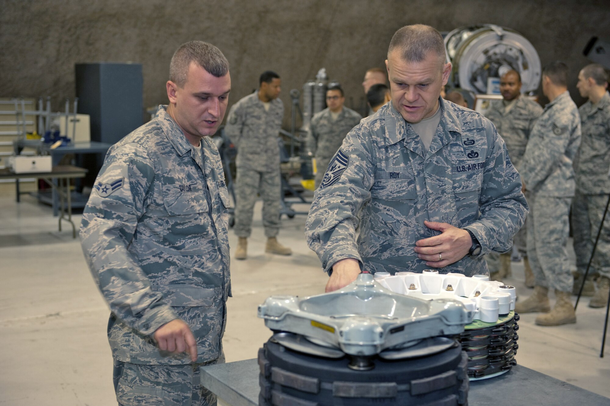 Chief Master Sgt. of the Air Force James A. Roy receives a briefing from Airman 1st Class Marcus Taylor about his role in maintaining aircraft brakes, Nov. 30, 2009. Chief Roy is touring the U.S. Air Forces Central Command area of responsibility, visiting with Airmen and addressing numerous issues affecting servicemembers who are deployed in support of operations Iraqi Freedom and Enduring Freedom. (U.S. Air Force photo/Staff Sgt. Robert Barney)
