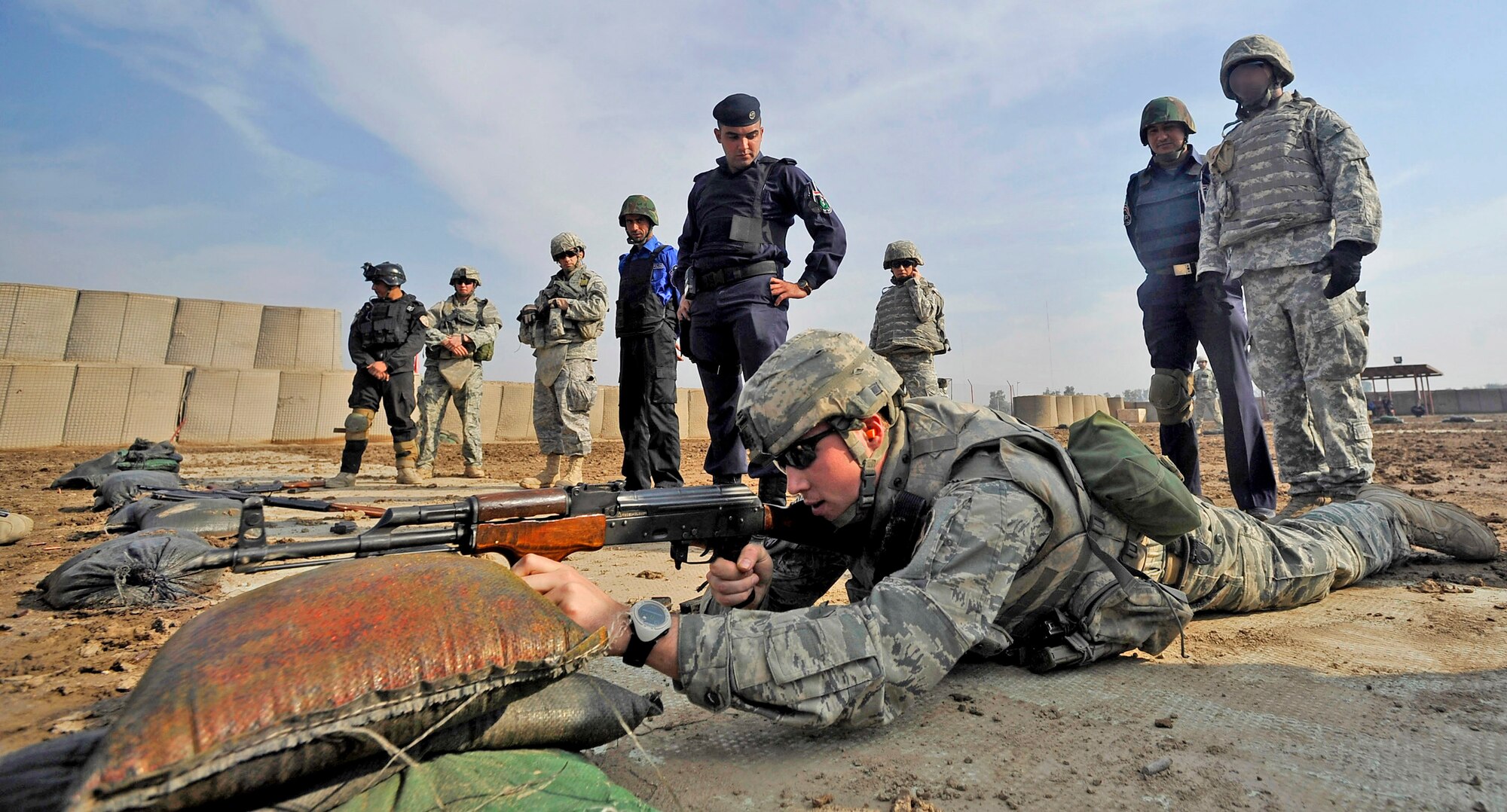 Staff Sgt Michael Gomez lies down in the prone supported position to demonstrate different shooting techniques to Iraqi police Nov. 18, 2009, in Baghdad, Iraq. Sergeant Gomez is assigned to the 732nd Expeditionary Security Forces Squadron Det. 2. (U.S. Air Force photo/Staff Sgt. Angelita Lawrence)