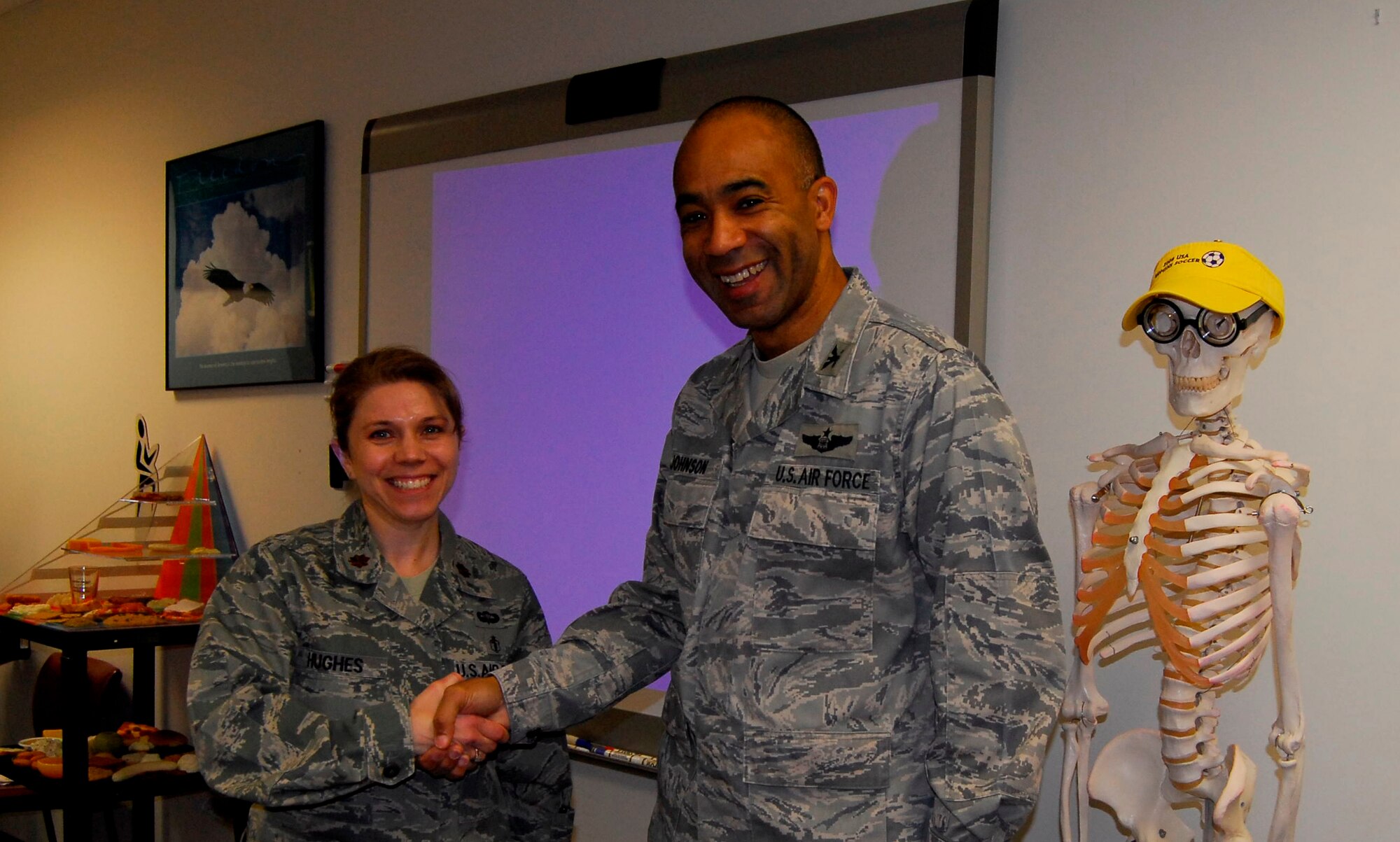 Col. James Johnson, 43rd Airlift Wing Commander, presented Maj. Teresa Hughes, 43rd Medical Group, a Commander’s Coin Dec. 1. (U.S. Air Force photo by 2nd Lt. Cammie Quinn)