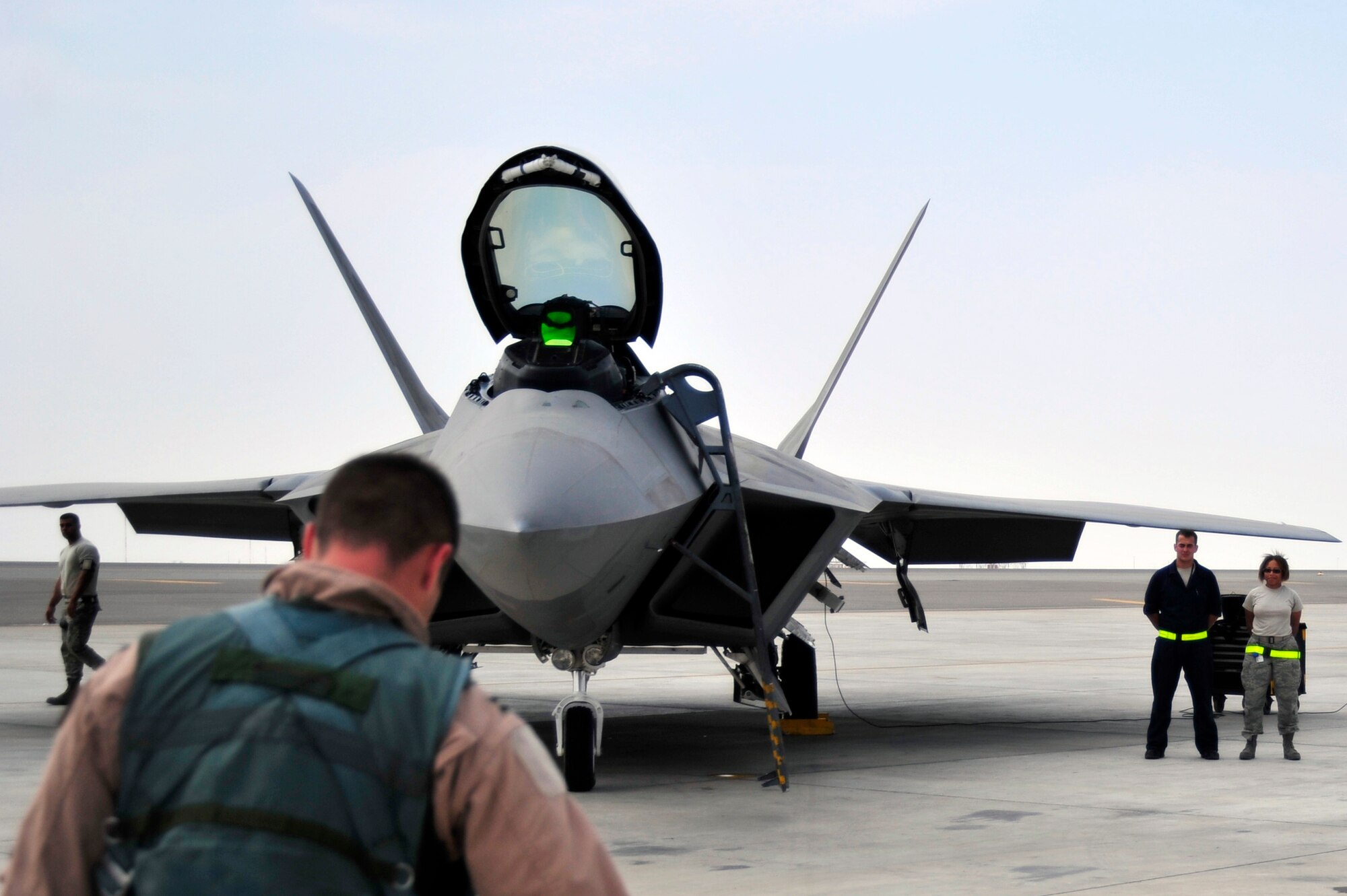 UNITED ARAB EMIRATES AIR WARFARE CENTER, UAE - Capt. Matthew Howard, 1st Fighter Wing pilot, prepares to board an F-22 Raptor Nov. 30, 2009. Captain Howard is on temporary duty from Langley Air Force Base, Va. Captain Howard hails from Warrensburg, Mo. F-22 Raptors have deployed from the 1st Fighter Wing at Langley AFB, VA to the United Arab Emirates Air Warfare Center.  Aircrews have been participating in bilateral training opportunities with Coalition partners.  The exercises are designed to promote security, stability and mutual interests in the region.  (U.S. Air Force photo/Tech. Sgt. Charles Larkin Sr).