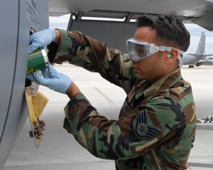 Staff Sergeant Glenn C. Meyers pours one quart of aircraft turbine engine synthetic oil (MIL-PRF-23699F) into the engine of a KC-135R Stratotanker at Pease Air National Guard Base, New Hampshire on May 3rd, 2009.    The aircraft and crew just returned from supporting an Air Expeditionary Force deployment to the United States Air Forces Central Area Of Responsibility (AOR). Staff. Sgt. Meyers is a crew chief assigned to the 157th Aircraft Maintenance Squadron here at Pease.  (U.S. Air Force photo/Staff Sgt. Curtis J.Lenz)