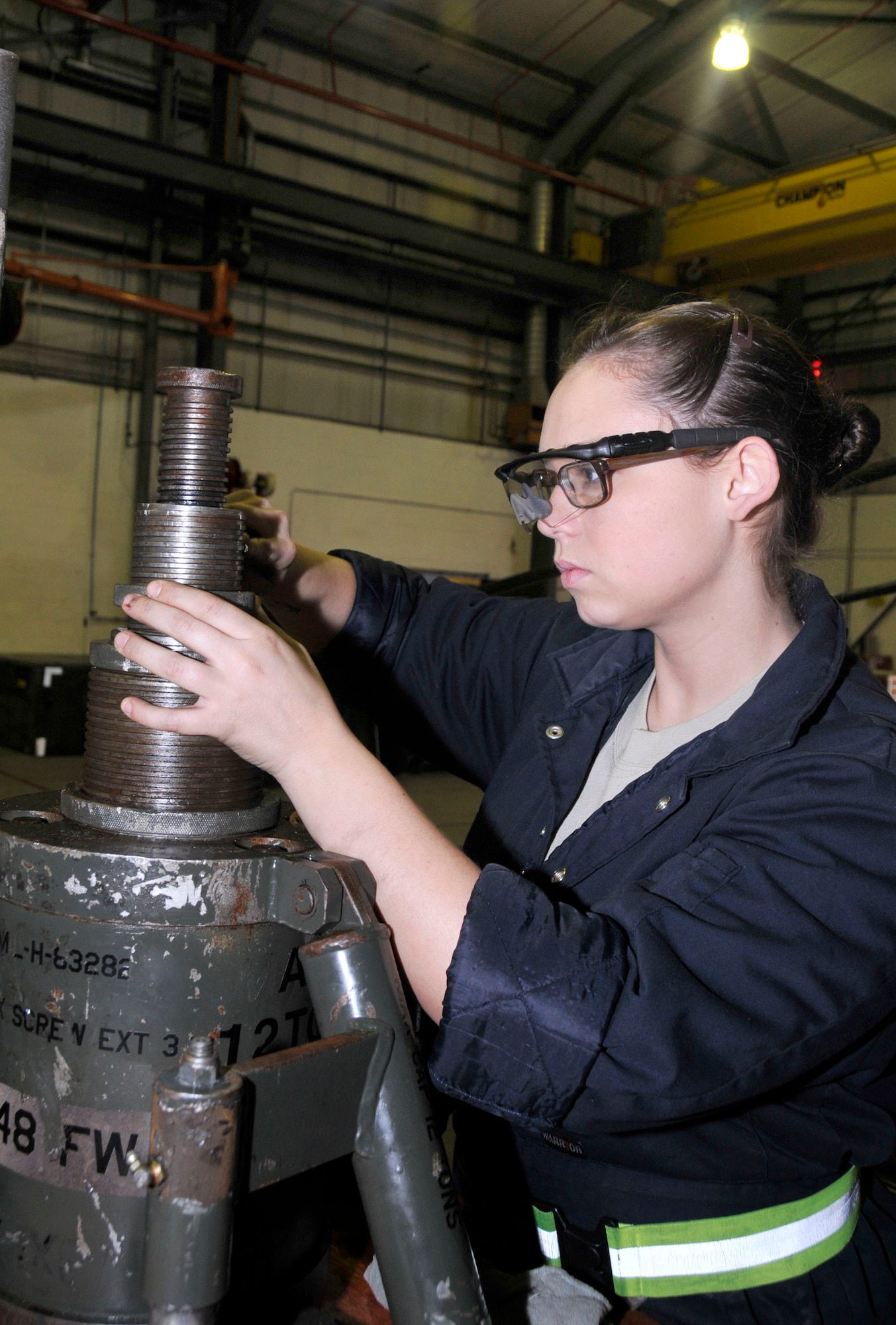 Airman 1st Class Maranda Perfetti , 48th Equipment Maintenance Squadron Aerospace Ground Equipment journeyman files down the grooves of a helicopter jack at the AGE shop on RAF Lakenheath, England, Nov. 24.  Helicopter parts are repaired by the Wing Team which also provides base support. (U.S. Air Force photo/Airman 1st Class Eboni Knox)