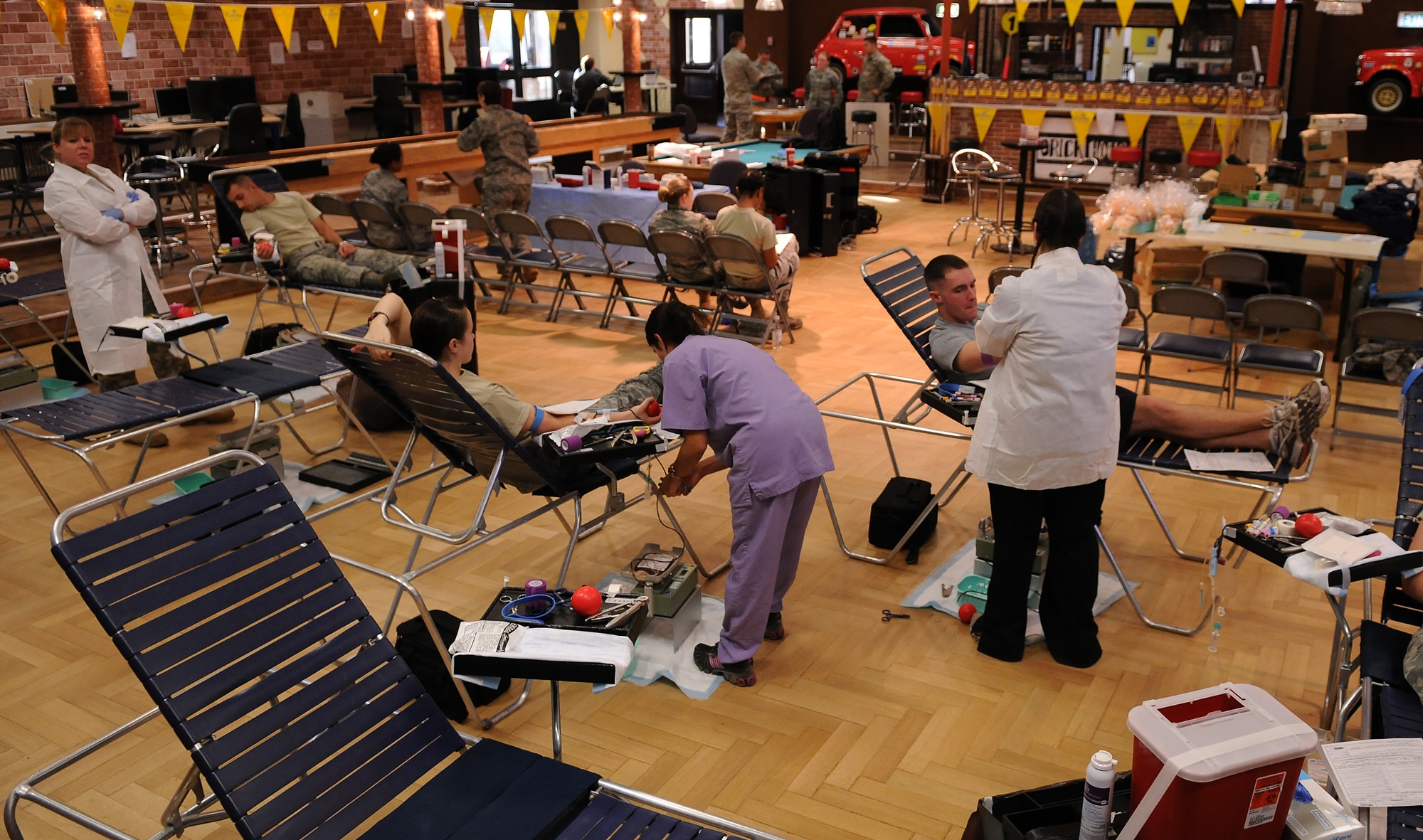 SPANGDAHLEM AIR BASE, Germany -- Technicians from the Armed Services Blood Bank Center-Europe receive blood from donors Dec. 2 at the Brick House. Members of the 52nd Fighter Wing donated blood during the Spangdahlem Community Blood Drive, which provided blood donations to the Armed Services Blood Program that distributes blood products to servicemembers and their families around the world. (U.S. Air Force photo/Airman 1st Class Nathanael Callon)