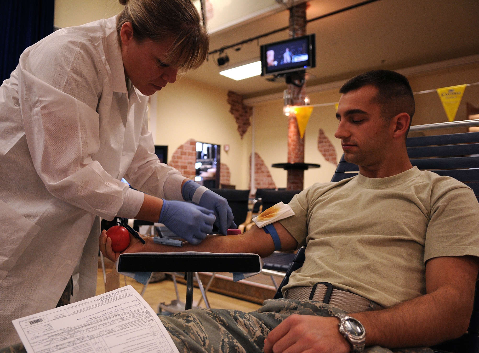 SPANGDAHLEM AIR BASE, Germany -- Army Sgt. Sylvia Sacco, Armed Services Blood Bank Center-Europe, prepares to withdraw blood from 2nd Lt. Gregory Stafford, 52nd Communications Squadron, Dec. 2 at the Brick House. The Armed Services Blood Program provides blood products for servicemembers and their families around the world. (U.S. Air Force photo/Airman 1st Class Nathanael Callon)