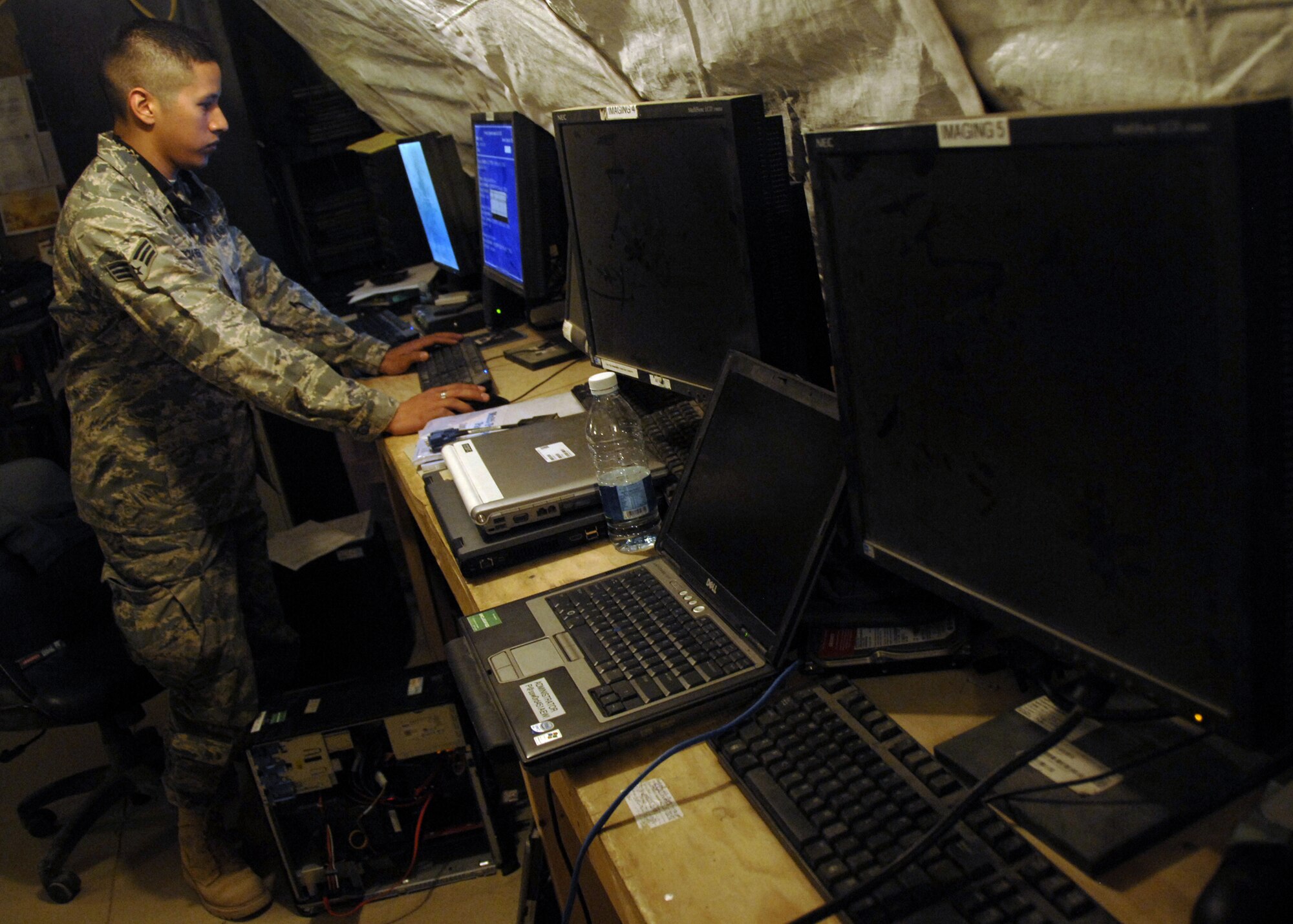 KANDAHAR AIRFIELD, Afghanistan - Senior Airman Steven Garcia-Renteria troubleshoots a computer issue here Nov. 28. Airman Garcia-Renteria is a network defense specialist with the 451st Expeditionary Communications Squadron. (U.S. Air Force photo/Senior Airman Timothy Taylor)

