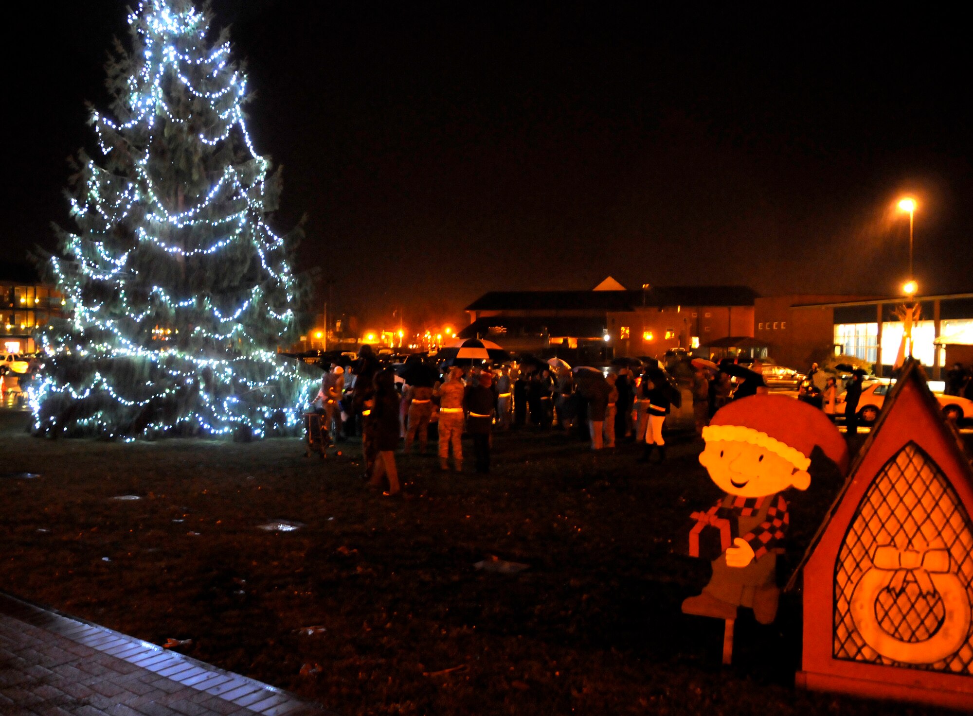 RAF MILDENHALL, England -- Military Families cheer as Col. Chad Manske, 100th Air Refueling Wing commander, lights the Christmas tree after children from the base youth center sang carols Dec. 2.  (U.S. Air Force photo/Staff Sgt. Christopher L. Ingersoll)