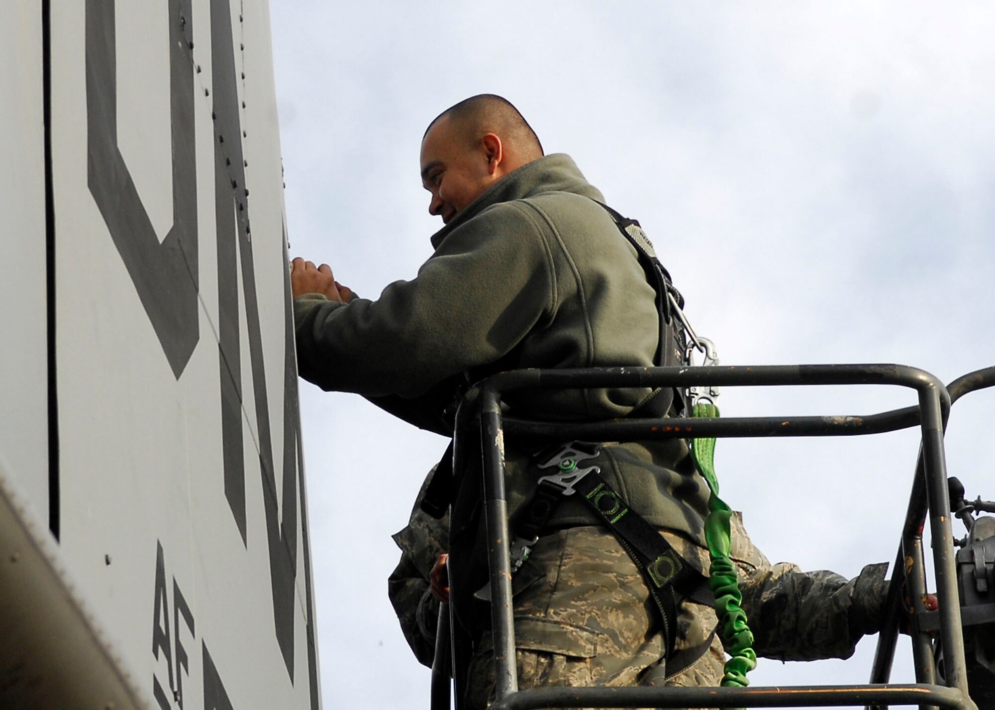 BAGRAM AIRFIELD, Afghanistan -- Tech. Sgt. Lee Fortner, a crew chief from the 41st Expeditionary Electronic Combat Squadron, removes screws from a panel on the EC-130 Compass Call so the aircraft can be inspected Dec. 3, 2009.  These inspections are important because the EC-130?s primary mission is to support tactical air operations.  Sergeant Fortner is deployed from Davis-Monthan Air Force Base, Ariz., and hails from Las Vegas.  (U.S. Air Force photo/Senior Airman Felicia Juenke)