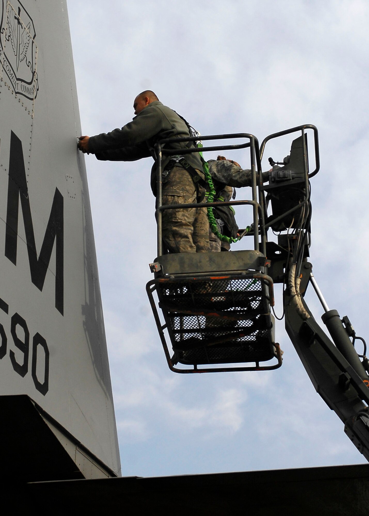 BAGRAM AIRFIELD, Afghanistan -- Tech. Sgt. Lee Fortner, a crew chief from the 41st Expeditionary Electronic Combat Squadron, removes screws from a panel on the EC-130 Compass Call so the aircraft can be inspected Dec. 3, 2009.  These inspections are important because the EC-130?s primary mission is to support tactical air operations.  Sergeant Fortner is deployed from Davis-Monthan Air Force Base, Ariz., and hails from Las Vegas.  (U.S. Air Force photo/Senior Airman Felicia Juenke)
