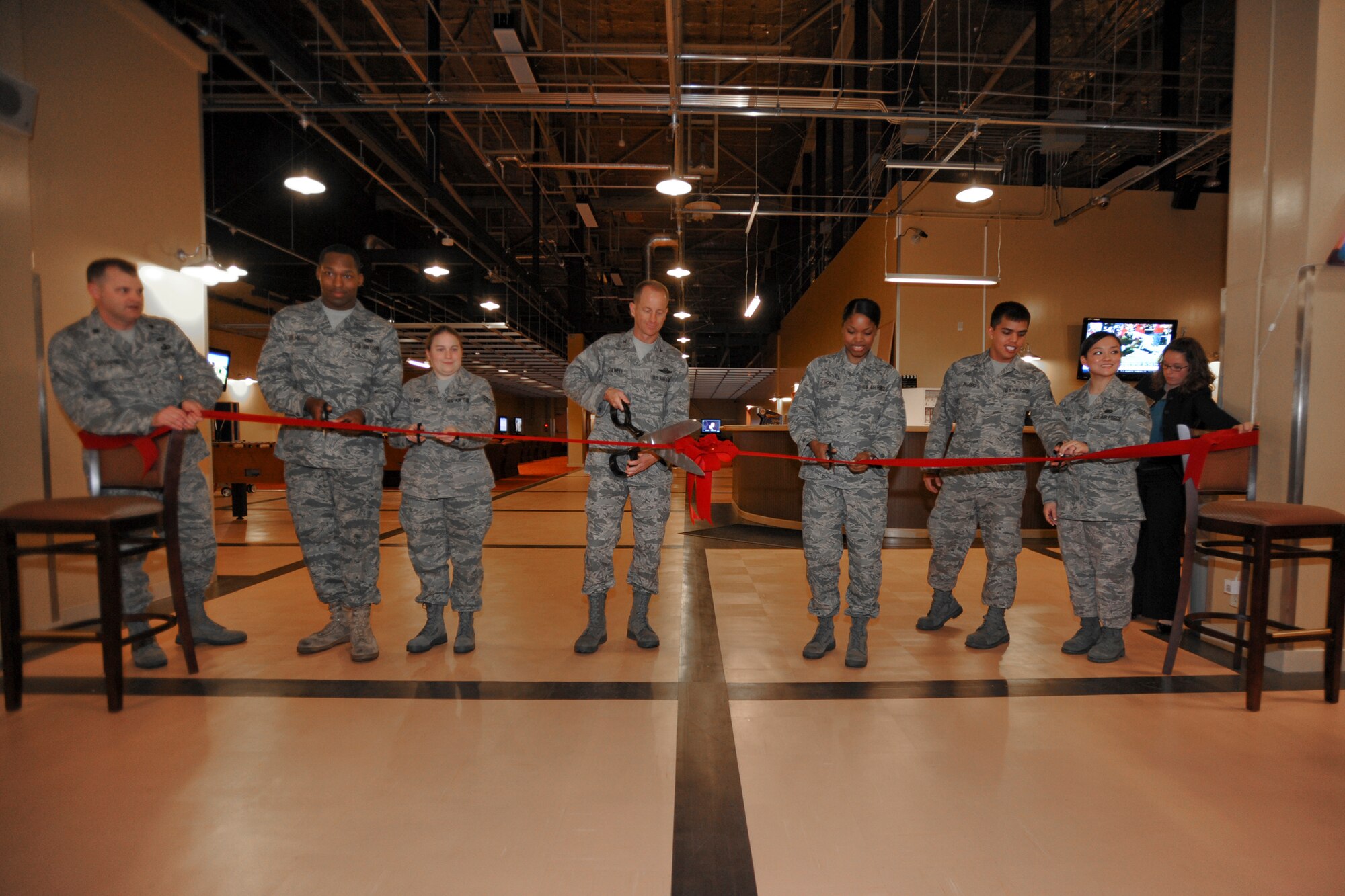 MISAWA AIR BASE, Japan -- Col. David Stilwell, 35th Fighter Wing commander, cuts the ribbon Dec. 3 commemorating the opening of the Airmen's Center. The center is open to enlisted members of all services E-4 and below and houses state-of-the-art equipment to include 21 big-screen televisions, three lounge areas, a 32-foot dance floor and much more. (U.S. Air Force photo/Senior Airman Jamal D. Sutter)