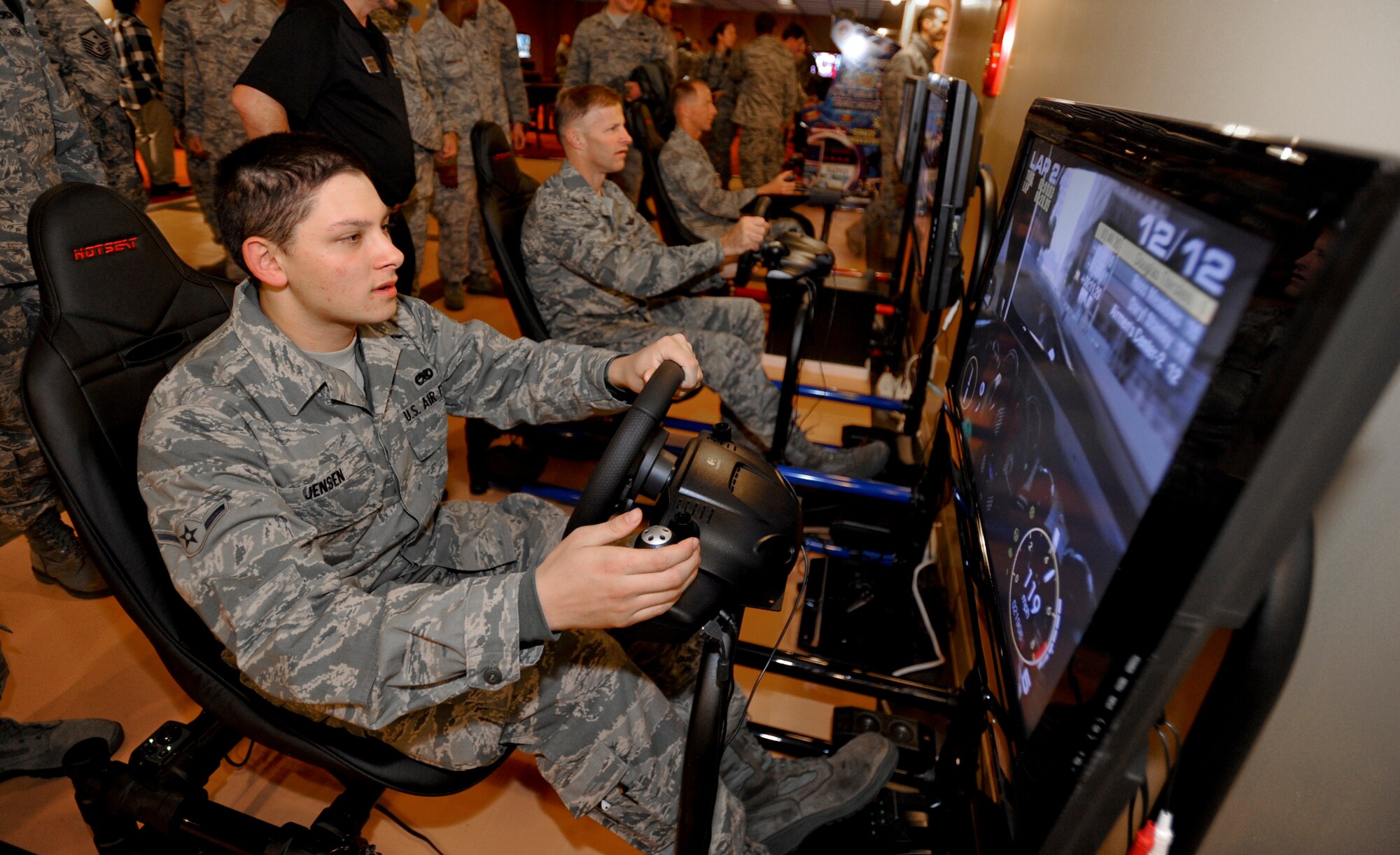 MISAWA AIR BASE, Japan -- Airman Christopher Jensen, 35th Aircraft Maintenance Squadron, Col. RC Craig, 35th Fighter Wing vice commander, and Col. David Stilwell, 35th FW commander, operate race and flight simulators Dec. 3 at the Airmen's Center. Dozens of service members of all ranks came out to support the event and take a peek at the new center. (U.S. Air Force photo/Senior Airman Jamal D. Sutter)