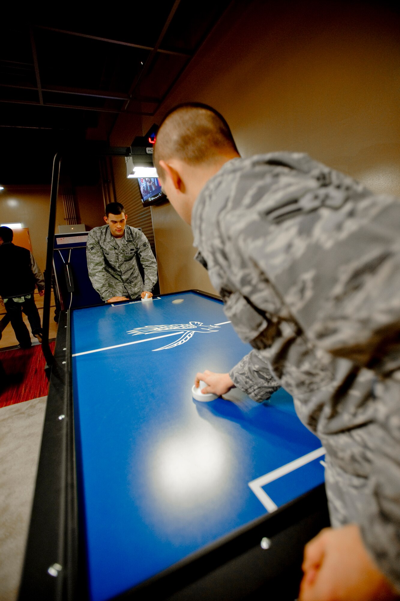 MISAWA AIR BASE, Japan -- Airman 1st Class Zachary Weiss and Airman 1st Class Andrew Ash, both of the 35th Logistics Readiness Squadron, become among the first to play a game of air hockey at the new Airmen's Center Dec.3. The new center has been under construction since November 2008. (U.S. Air Force photo/Senior Airman Jamal D. Sutter)