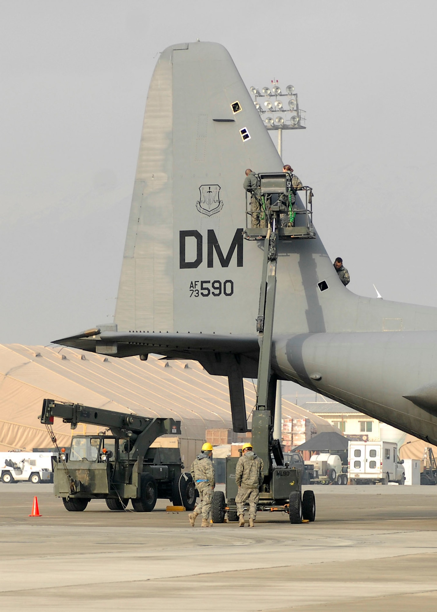 BAGRAM AIRFIELD, Afghanistan -- Airmen from the 41st Expeditionary Electronic Combat Squadron perform an inspection of the EC-130 Compass Call Dec. 3, 2009.  These inspections are important because the EC-130?s primary mission is to support tactical air operations, but also can provide jamming support to ground forces in support of Operation Enduring Freedom.  The Compass Call system employs offensive capabilities in support of U.S. and Coalition tactical air, surface, and special operations forces.  (U.S. Air Force photo/Senior Airman Felicia Juenke)