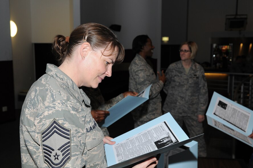 Chief Master Sgt. Shona Lawrence, USAFE/A4R reviews “charter chief” enlisted heritage information at the recent Ramstein Area Chiefs Group 50-year celebration of the chief rank at the enlisted club Dec. 1. (U.S. Air Force photo by Airman 1st Class Caleb Pierce)
