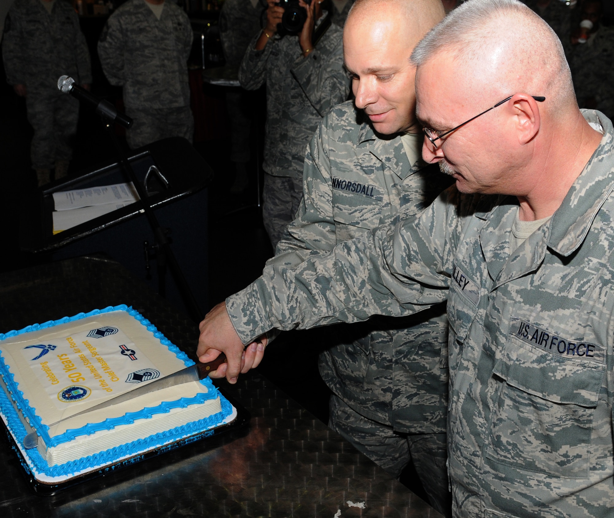 Chief Master Sgt. Dennis Vannorsdall, 3rd Air Force Command Chief and Senior Master Sgt. Joel Tilley, 86th Mission Support Squadron Professional Enhancement Center superintendent and soon to be Ramstein’s newest chief with his promotion on Jan. 1. 2010, cut the Ramstein Area Chiefs Group cake to celebrate the 50th anniversary of the chief master sergeant rank at Ramstein’s enlisted club Dec. 1. (U.S. Air Force photo by Airman 1st Class Caleb Pierce) 