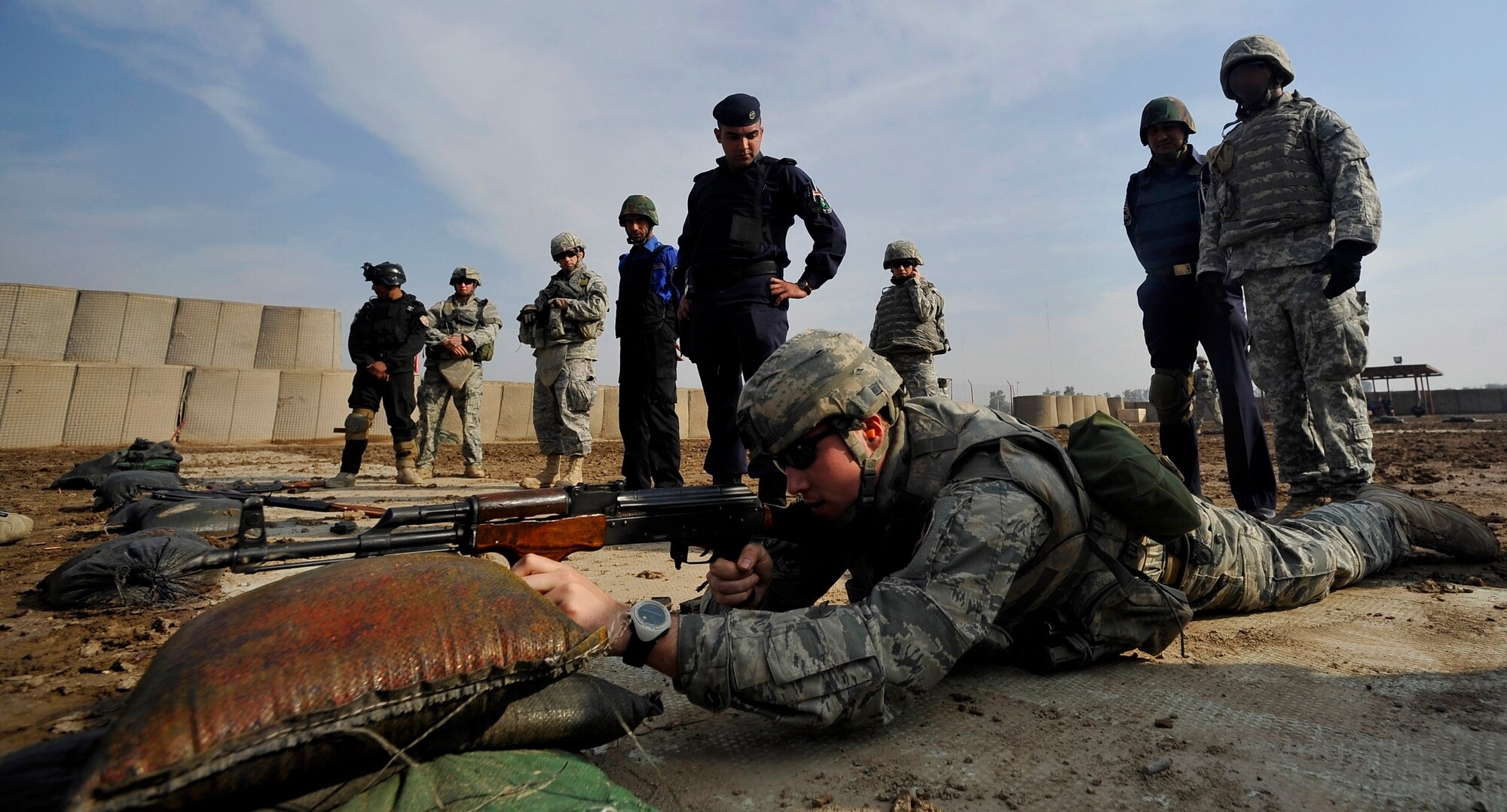 U.S. Air Force Staff Sgt Michael Gomez, a Defender assigned to the 732nd Expeditionary Security Forces Squadron Det. 2, deployed to Baghdad, Iraq, lays down in the prone supported position to demonstrate different shooting techniques to the Iraqi Police, Nov. 18, 2009. (U.S. Air Force photo/Staff Sgt. Angelita Lawrence)
