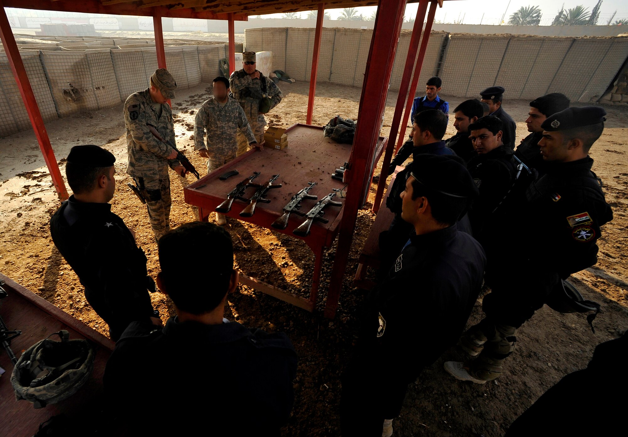 U.S. Air Force Staff Sgt. Michael Gomez, a Defender assigned to the 732nd Expeditionary Security Forces Squadron Det 2, deployed to Baghdad, Iraq, instructs new Iraqi Police officers at a firing range, Nov. 21, 2009. (U.S. Air Force photo/Staff Sgt. Angelita Lawrence)