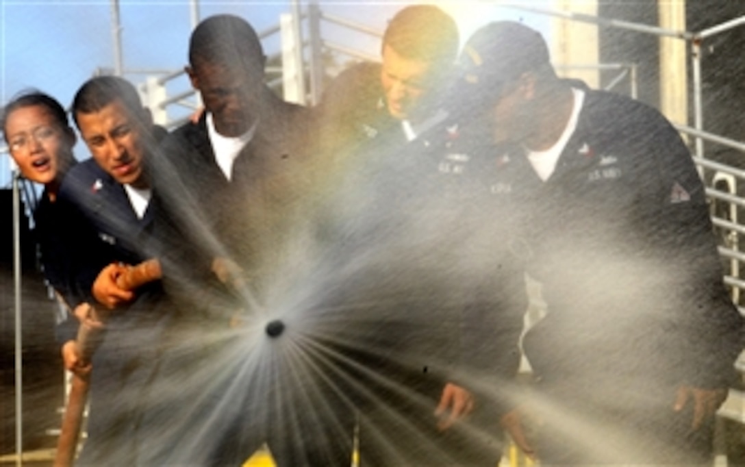 U.S. Navy sailors assigned to the destroyer USS Chung-Hoon (DDG 93) cycle through hose settings during the annual Surface Line Week’s damage control Olympics in Pearl Harbor, Hawaii, on Nov. 30, 2009.  Surface Line Week promotes camaraderie between ships and shipmates on the Pearl Harbor waterfront through professional competition and is hosted by Afloat Training Group Middle Pacific.  