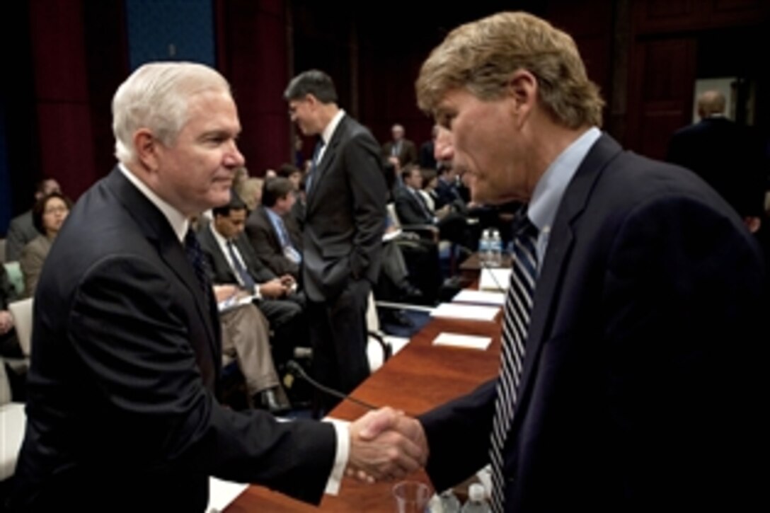 Defense Secretary Robert M. Gates greets Rep. Gene Taylor, D-Miss., before testifying at the House Armed Services Committee in Washington, D.C., Dec. 3, 2009. The hearing focused on President Barack Obama's decision to send an additional 30,000 troops to the war in Afghanistan.