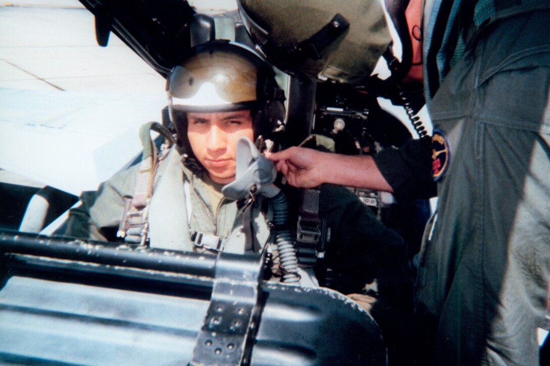 Major Lyne Mills helps strap Corporal Juan Gonzalez into the back seat of an F/A-18 Hornet prior to conducting preflight procedures before launch.  Gonzalez was awarded an incentive ride after being named Marine Fighter Attack Training Squadron 101's Marine of the Quarter for 3rd quarter of 2004.  Corporal Gonzalez is the squadron's Security Assistant and is from Santa Barbara, California.