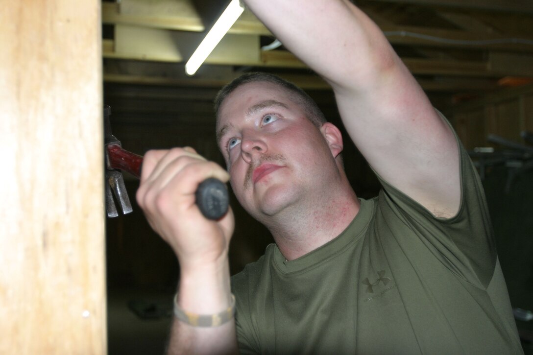 CAMP AL QAIM, Iraq (March 6, 2005)- Lance Cpl. Kevin D. Taylor, a machine gunner with 3rd Battalion, 2d Marine Regiment works on making his living area more comfortable. The Warren, Ohio, native gave up his own construction business to join the Marine Corps. Official U.S. Marine Corps photo by Lance Cpl. Lucian Friel (RELEASED)