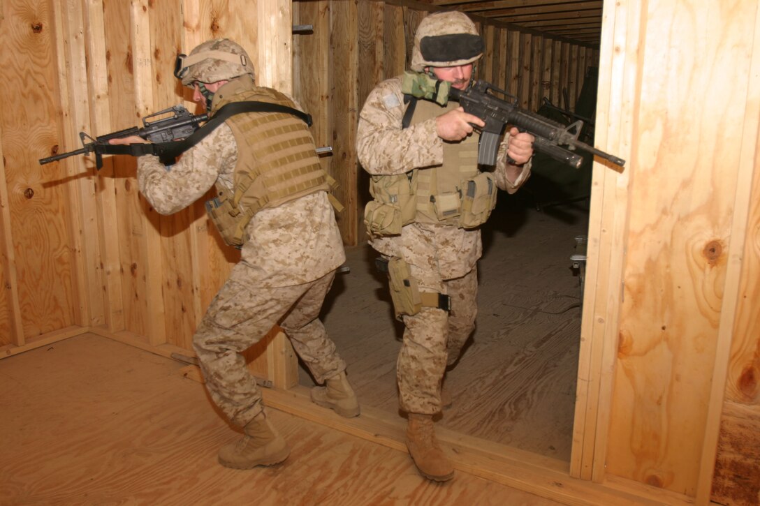 CAMP AL QAIM, Iraq (March 7, 2005)- Sgt. Matthew I. Campbell, a machine gunner with 3rd Battalion, 2d Marine Regiment and Cpl. Anthony G. Zoccano, a rifleman with the battalion clear a room during training here.  Campbell teaches his Marines close quarters combat here during their down time. The Moreno Valley, Calif., native joined the Marine Corps in 2000 after working as an aviation technician.Official U.S. Marine Corps photo by Lance Cpl. Lucian Friel (RELEASED)