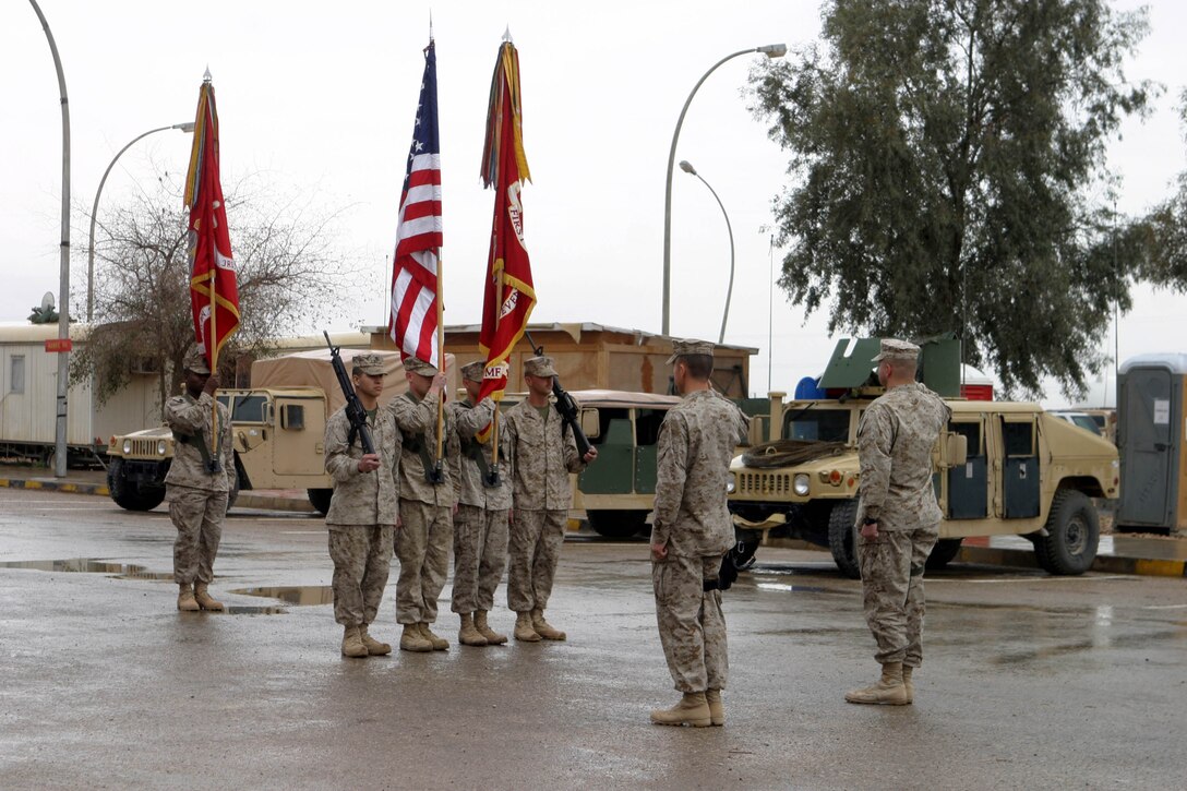 CAMP AL QAIM, IRAQ (March 9, 2005)- Lt. Col. Timothy S. Mundy (left), commanding officer of 3rd Battalion, 2d Marine Regiment and Lt. Col. Christopher Woodridge (right), commanding officer of 1st Battalion, 7th Marine Regiment salute the colors during a Ceremony here March 9. The ceremony officially marked Marines of 3rd Battalion, 2d Marines assuming control of the region around Al Qaim from 1st Battalion, 7th Marines after their successful seven-month tour. Official U. S. Marine Corps photo by Lance Cpl. Christopher G. Graham (RELEASED)