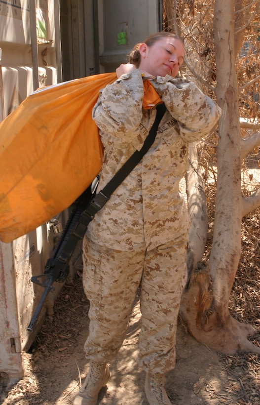 Lance Cpl. Holly Charette, a 21-year-old from Cranston, R.I., delivers Headquarters Battalion Marines' mail, March 17.  Charette recently deployed here from her home base at Camp Lejeune, N.C. to serve in Operation Iraqi Freedom.  U.S. Marine Corps photo by Sgt. Stephen D'Alessio (RELEASED)