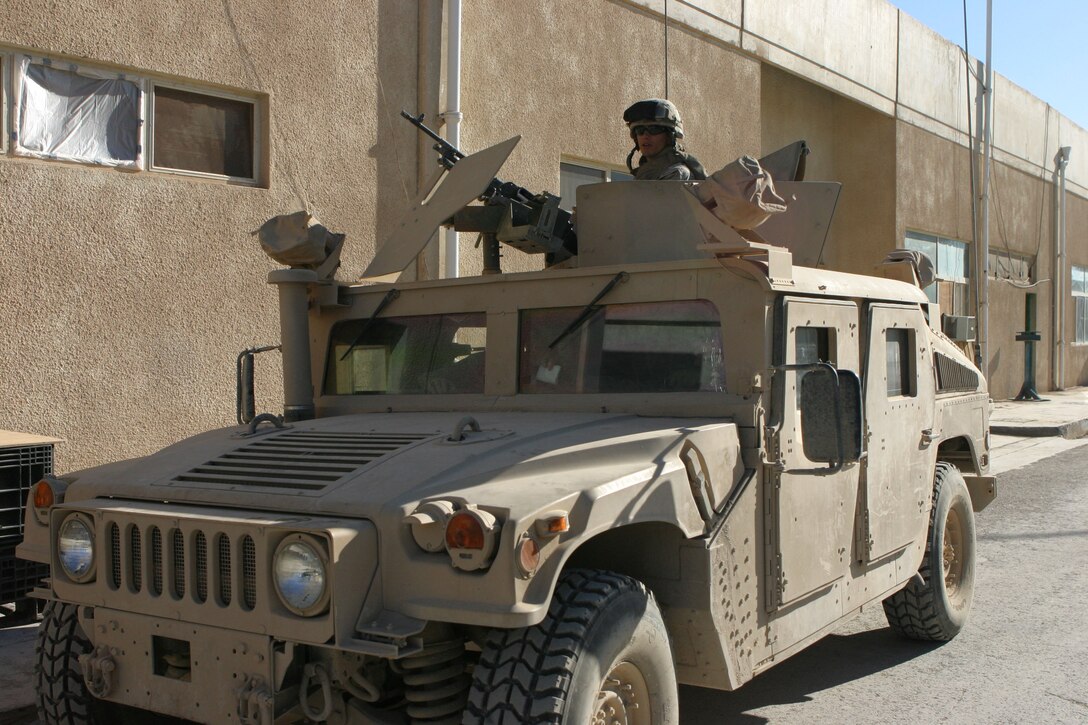 CAMP AL QA'IM, Iraq (March 18, 2005)- Pvt. Nick Luciano, a gunner with the security platoon of 3rd Battalion, 2d Marine Regiment prepares his weapon before the convoy leaves. The Candon, N.J., native was in the rear vehicle of the convoy, which was responsible for rear security. The convoy was to resupply Marines with Company I in Husaybah. Official U.S. Marine Corps photo by Lance Cpl. Lucian Friel (RELEASED)