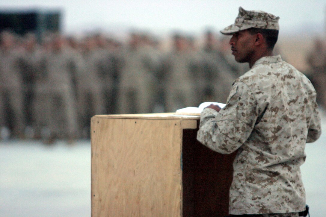 CAMP AL QA'IM, Iraq (March 22, 2005)- Sgt. Clive S. Chinatomby with 3rd Battalion, 2nd Marine Regiment honors his fallen brother Lance Cpl. Kevin Smith who was killed in action by a vehicle borne improvised explosive device March 21. The Memorial ceremony took place here March 22. Chinatomby, Smith's squad leader, gives a memorial speech in honor of Smith, who was with the battalion's security platoon. Official U.S. Marine Corps photo by Lance Cpl. Lucian Friel (RELEASED)