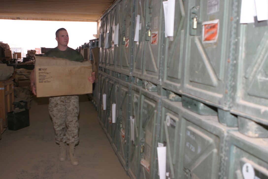 CAMP AL QA'IM, Iraq (March 23, 2005)- Cpl. James D. Fay, 21, a nuclear, biological and chemical defense specialist with 3rd Battalion, 2nd Marine Regiment inventories the NBC gear here. This is the South Hadley, Mass., native's first deployment to Iraq. As a watch clerk in the combat operations center, Fay is responsible for keeping track of all information that comes into the C.O.C. Fay joined the Marine Corps to straighten himself out and now three years later, he wants to reenlist. Official U.S. Marine Corps photo by Lance Cpl. Lucian Friel (RELEASED)