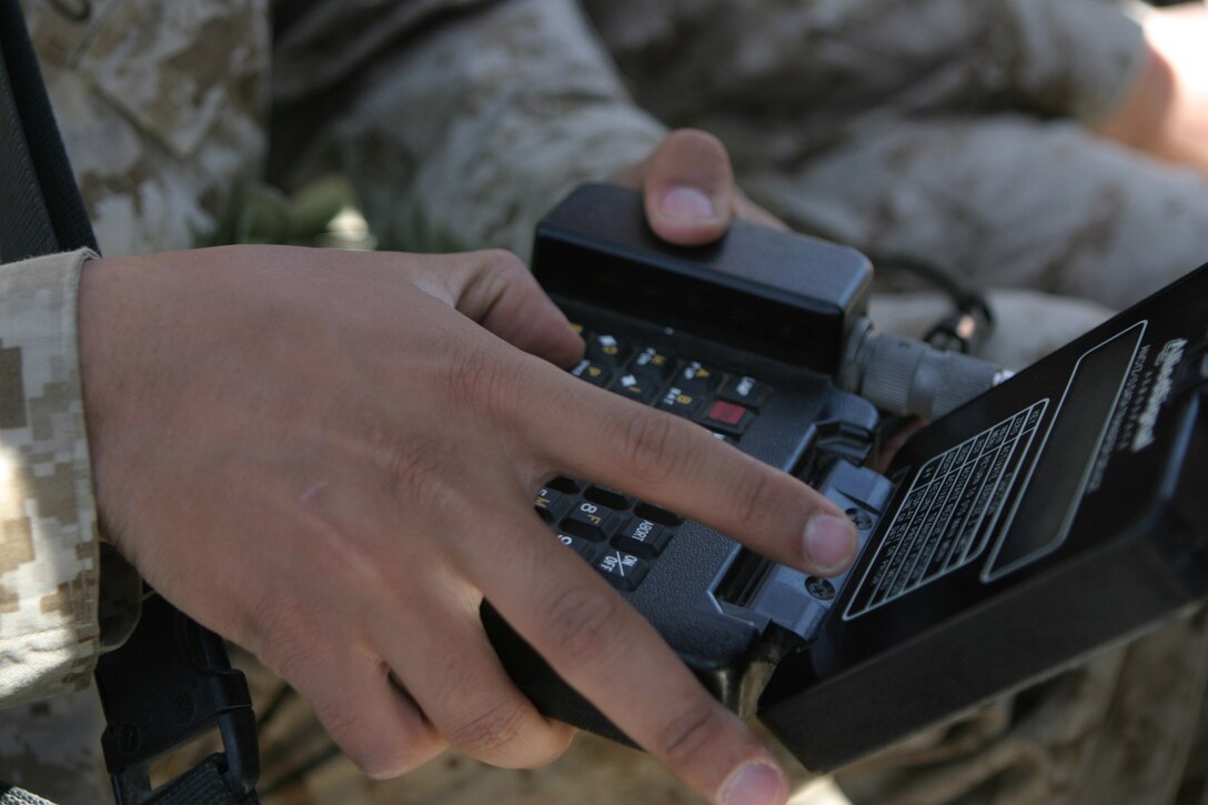 CAMP BLUE DIAMOND, AR RAMADI, Iraq -- Lance Cpl. Carlos Garza, a 20-year-old Houston, Texas native and administration clerk with Headquarters Battalion, uses a piece of cryptological equipment while learning how to use the Personnel Radio Component 119 (PRK-119) system, March 24.  The VHF radio is the Corps' main mode of communication in ground combat operations for Operation Iraqi Freedom.  U.S. Marine Corps photo by Sgt. Stephen D'Alessio (RELEASED)
