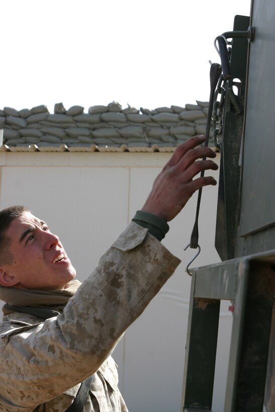 JORDANIAN BORDER, Iraq -- Lance Corporal Ben Gunderson a 20-year-old Gaylord, Mich. native and motor transportation operator with 2nd Marine Division, Headquarters Battalion, Truck Co., climbs into the cab of his 7-Ton Truck for a pre-convoy inspection, March 26.  Gunderson is a 2002 Gaylord High School graduate and veteran of two tours in Operation Iraqi Freedom.  U.S. Marine Corps photo by Sgt. Stephen D'Alessio (RELEASED)