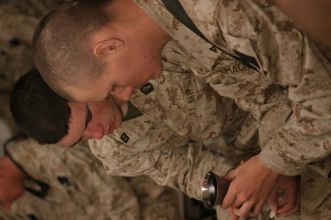 CAMP FALLUJAH, IRAQ – Marines take part in communion during the Easter Sunday service held at the battalion chapel, which was led by the Battalion Chaplain Navy Lt. Robert E. Bradshaw.  Everyone who wanted was able to take part in communion.  Official U.S. Marine Corps photo by Lance Cpl. Athanasios L. Genos